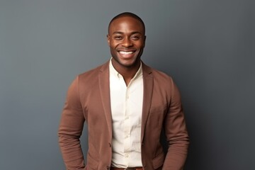 Obraz premium Portrait of happy african american man in jacket on grey background