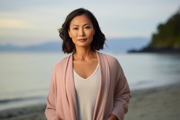 Portrait of a beautiful young asian woman standing on the beach