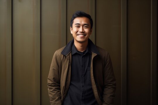 Portrait of a Indonesian man in his 30s in an abstract background wearing a chic cardigan