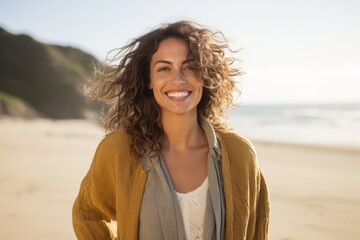 Fototapeta na wymiar Portrait of a Brazilian woman in her 30s in a beach background wearing a chic cardigan