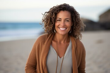 Portrait of a beautiful woman smiling at the camera on the beach