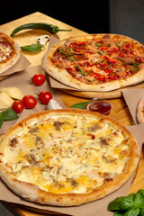 Set of different baked pizzas on a wooden table. Menu for restaurant, pizzeria. Assortment of pizzas.