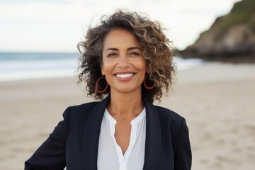 Portrait of a smiling businesswoman standing on the beach at the day time