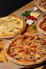 Set of different baked pizzas on a wooden table. Menu for restaurant, pizzeria. Assortment of pizzas.