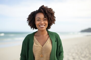 Portrait of smiling african american woman standing on the beach