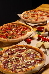 Set of different baked pizzas on a wooden table. Menu for restaurant, pizzeria. Assortment of pizzas.