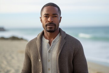 Portrait of a handsome man standing on the beach at the day time