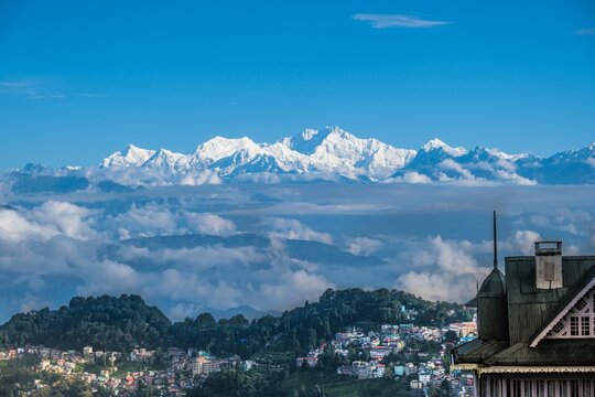 Aerial view of town Darjeeling surrounded by buildings in background of mountain Kanchenjunga