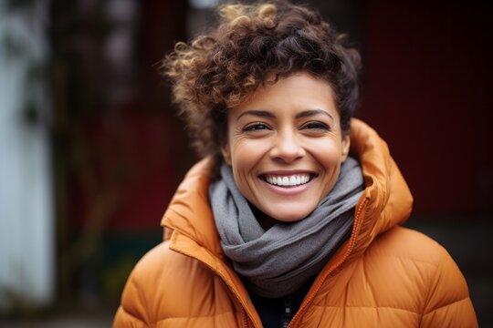 Portrait of a Brazilian woman in her 40s in an abstract background wearing a warm parka