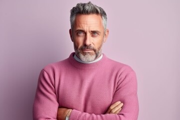 Medium shot portrait of a Russian man in his 40s in a pastel or soft colors background wearing a chic cardigan