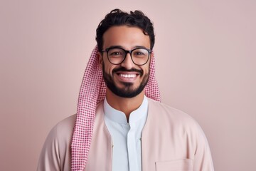 Obraz premium Medium shot portrait of a Saudi Arabian man in his 30s in a pastel or soft colors background wearing a chic cardigan