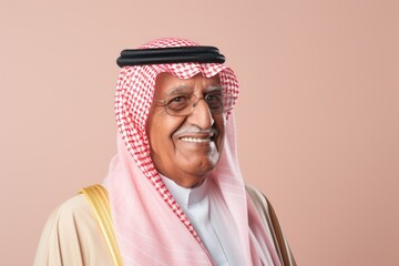 Portrait of a 100-year-old elderly Saudi Arabian man in a pastel or soft colors background wearing a chic cardigan