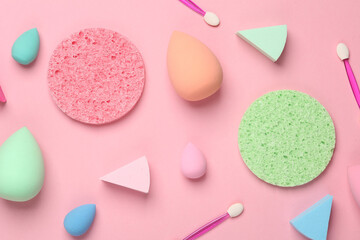 Make-up sponge, cosmetic blenders and applicators for makeup on pink background. Beauty products. Top view. Flat lay