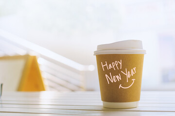 Happy New Year. Handwritten message on recycled coffee mug. A fresh start for the environment.