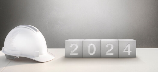 Happy New Year 2024 Construction and Industry. Helmet and a numbered concrete cube on the desk of an engineer or construction worker.	