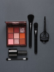 Set of beauty products, make-up accessories on a dark background. Flat lay