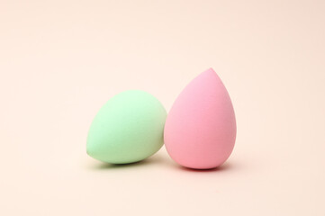 Make-up sponges, cosmetic blenders on beige background. Beauty products.