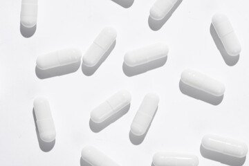 White pills on white background. Creative layout