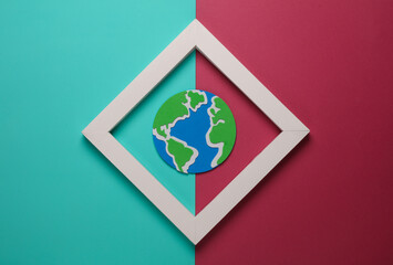 Globe in white frame on pink blue background. Creative layout. Minimalism