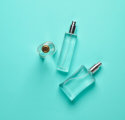 Perfume bottles on blue background. Creative beauty layout. Minimalism