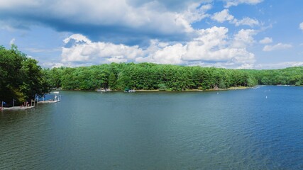 Fototapeta premium a wide blue lake with people on it in the middle
