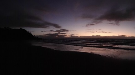 Fototapeta na wymiar Picturesque scene of an ocean at dusk, with dark blue waves