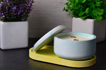 there is a candle on a stand near two vases
