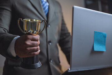 Businessman, success, company president Holding an outstanding trophy for corporate development of an investment company
