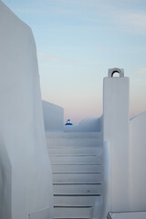 Characteristic, Greek whitewashed stairway with top of a Greek church in the background. 