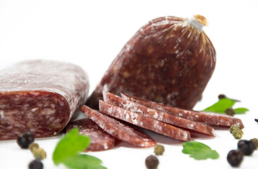 Tasty sausages and vegetables isolated over solid background