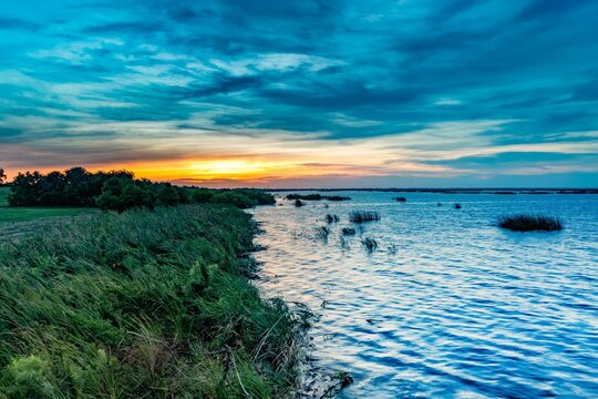 Aerial view of Lake Okeechobee surrounded by lush greenery at sunset in Florida, the United States