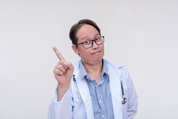A doctor giving pointers and reminders. Finger wagging saying no. Of asian descent, middle aged...