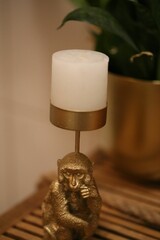 Closeup of a decorative golden monkey candle holder.