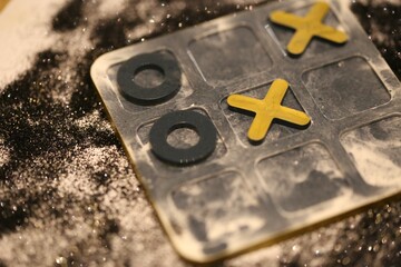 plastic board with the traditional tic-tac-toe game pieces arranged on the surface