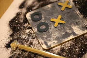 Close-up of a board game with tic tac toe game pieces - obrazy, fototapety, plakaty
