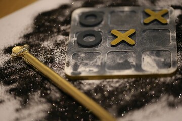 Close-up of a board game with tic tac toe game pieces - obrazy, fototapety, plakaty