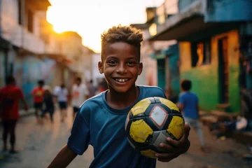 Fotobehang Rio de Janeiro Portrait of a brazilian boy holding a soccer ball and looking at the camera in a favela in Rio de Janeiro