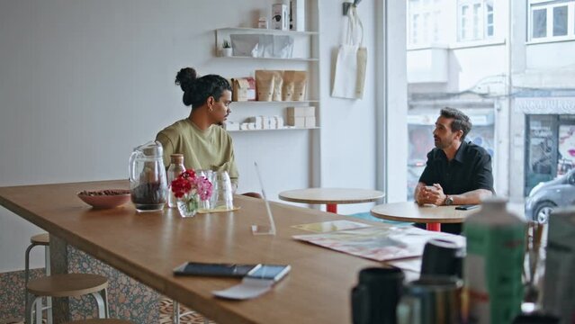 Two male strangers talking meeting in coffee house at weekend. Guys acquaintance