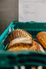 Close up of crusty fresh sourdough loaves in bakers crate ready for delivery