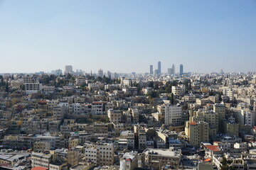 Fototapeta premium Panorama of Amman city in Jordan - the contrast of public housing and modern skyscrapers.