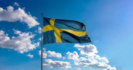 Swedish flag flutters in the wind, affixed to a tall pole under a bright blue sky