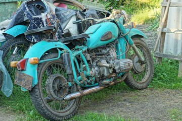 one old rusty iron classical  heavy big comfortable green color  retro   dirty made in the ussr retro  motorcycle stands on the street
