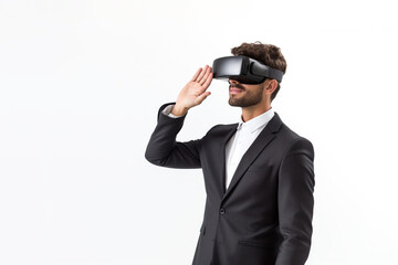 Young man wearing virtual reality VR glasses, VR headset and trying to touch something with his hand while standing on white background.