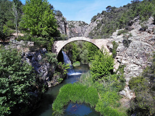 Clandiras Bridge, located in Usak, Turkey, was built during the Roman period. There is a waterfall right next to it.