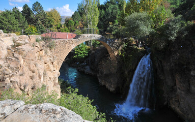 Fototapeta na wymiar Clandiras Bridge, located in Usak, Turkey, was built during the Roman period. There is a waterfall right next to it.