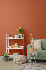 Interior of stylish living room with sofa, rack and Easter decor