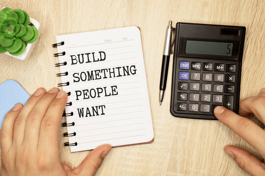 Build something people want.text on white notepad on craft background.