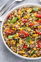 Warm quinoa salad with tomatoes, corn and zucchini