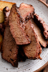 Sliced smoked brisket on a plate with toast