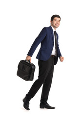 Young businessman with briefcase walking on white background